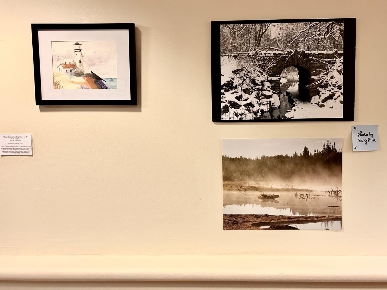 art hanging on the wall: a watercolor lighthouse and two nature photos