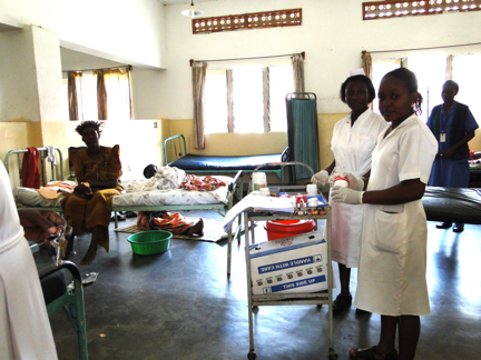 staff care for patients in a hospital room with beds