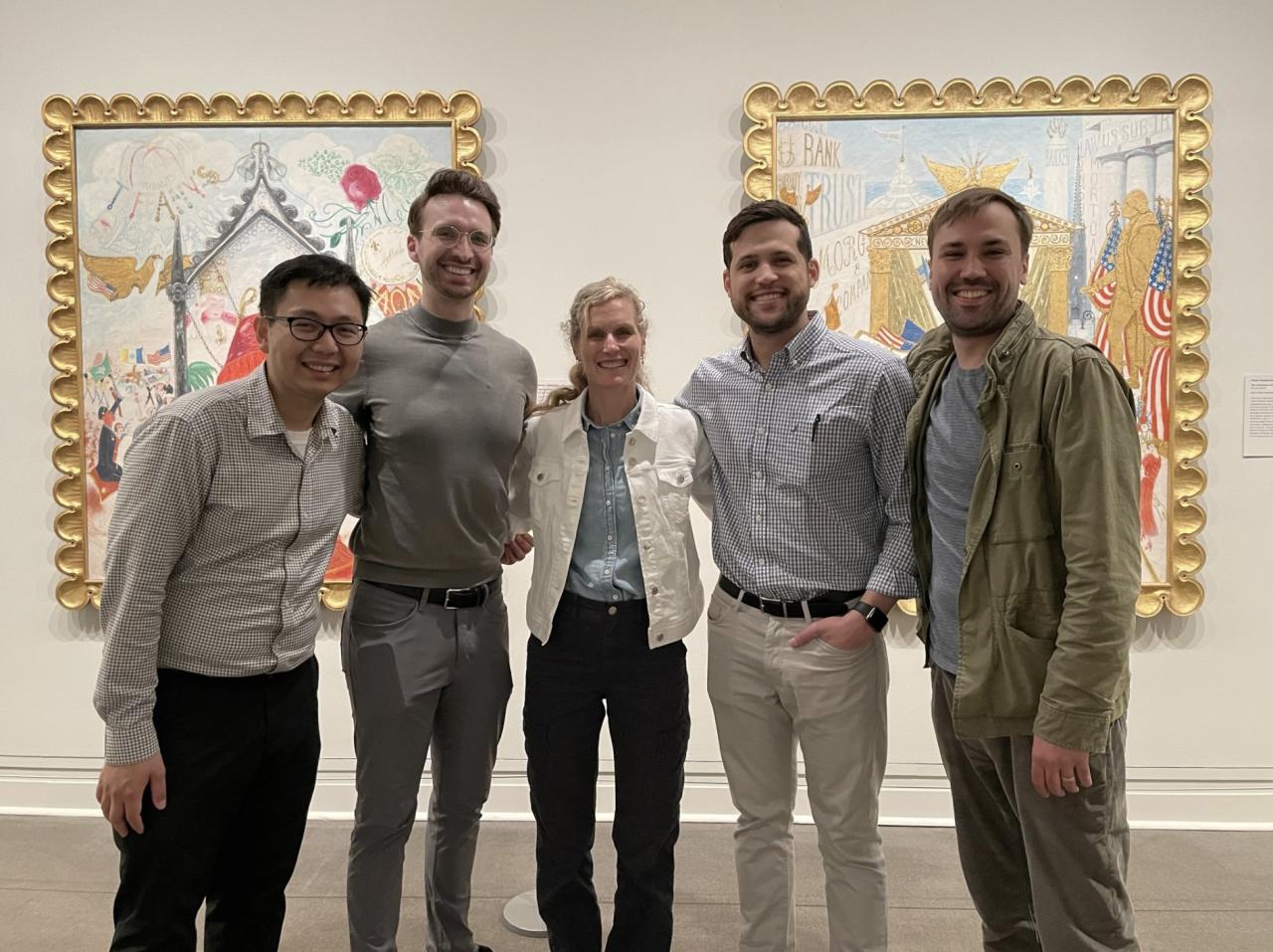 group poses in front of two art pieces at the Metropolitan Museum of Art